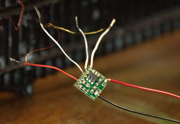 The Ngineering rotating beacon simulator board with leads attached.